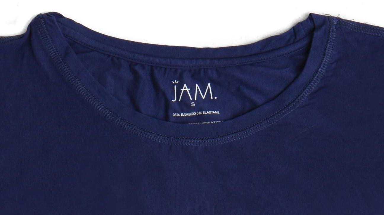 A close up image of the neck line of a navy tshirt that has it's care label screen printed on. The label reads "JAM, small, 95% bamboo, 5% elastane"