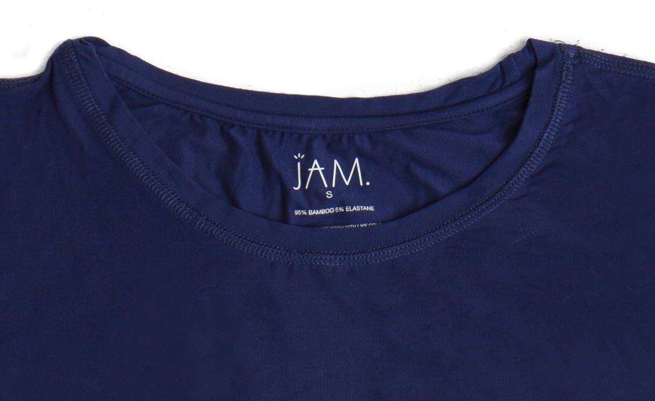 A close up image of the neck line of a navy tshirt that has it's care label screen printed on. The label reads "JAM, small, 95% bamboo, 5% elastane"